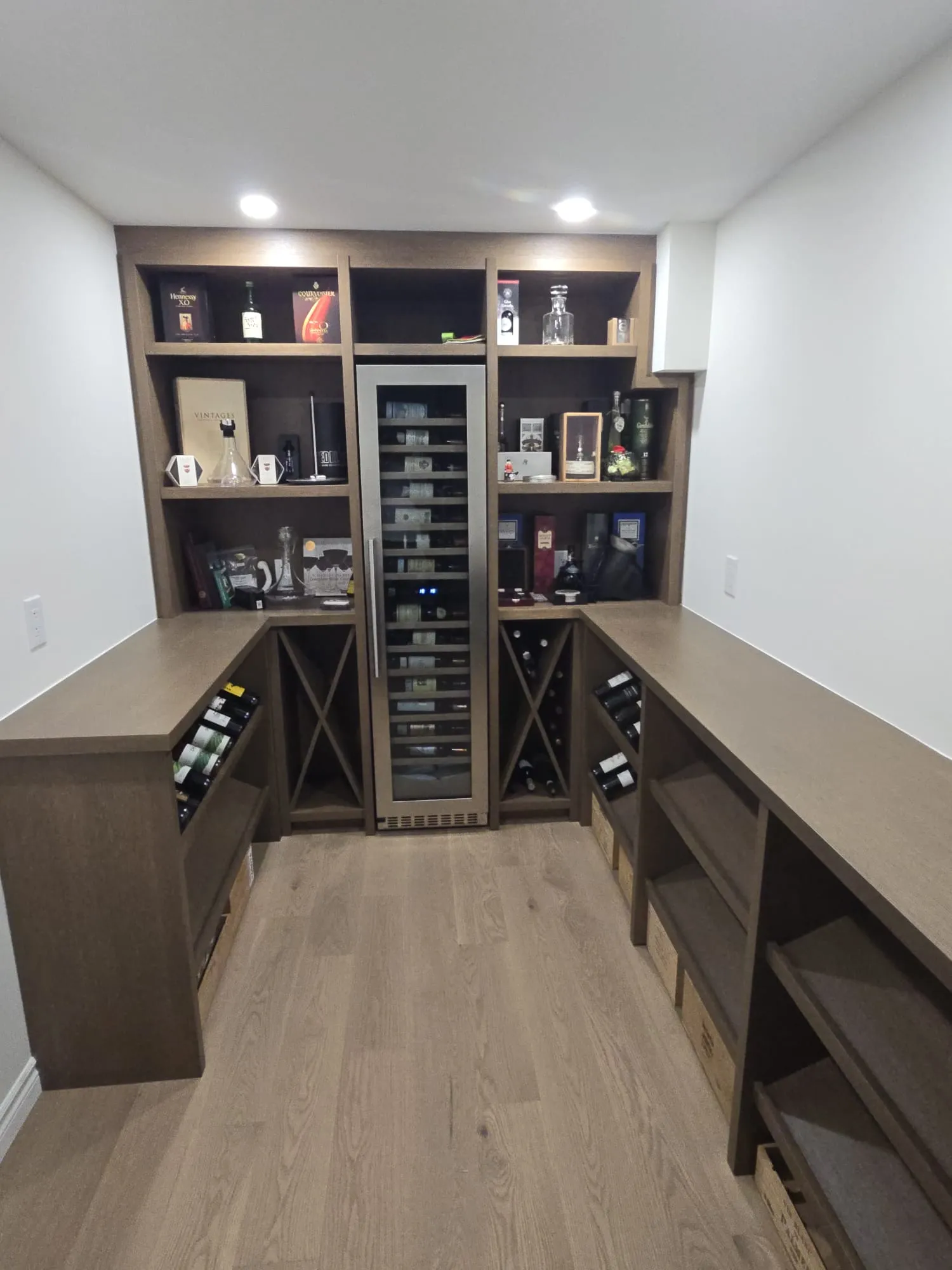 Wood beverage cabinetry with wine fridge and bottle cubbies