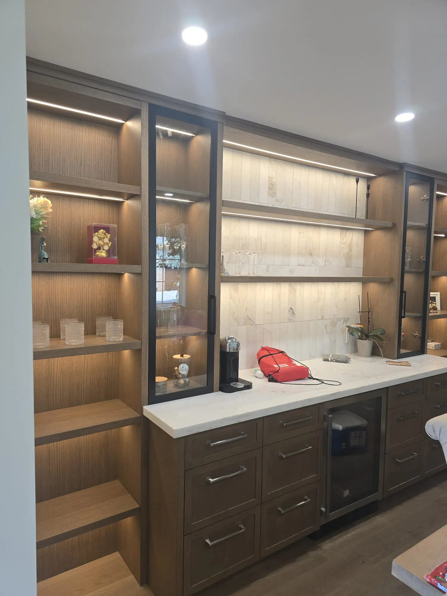 Illuminated dark wood display cabinetry
