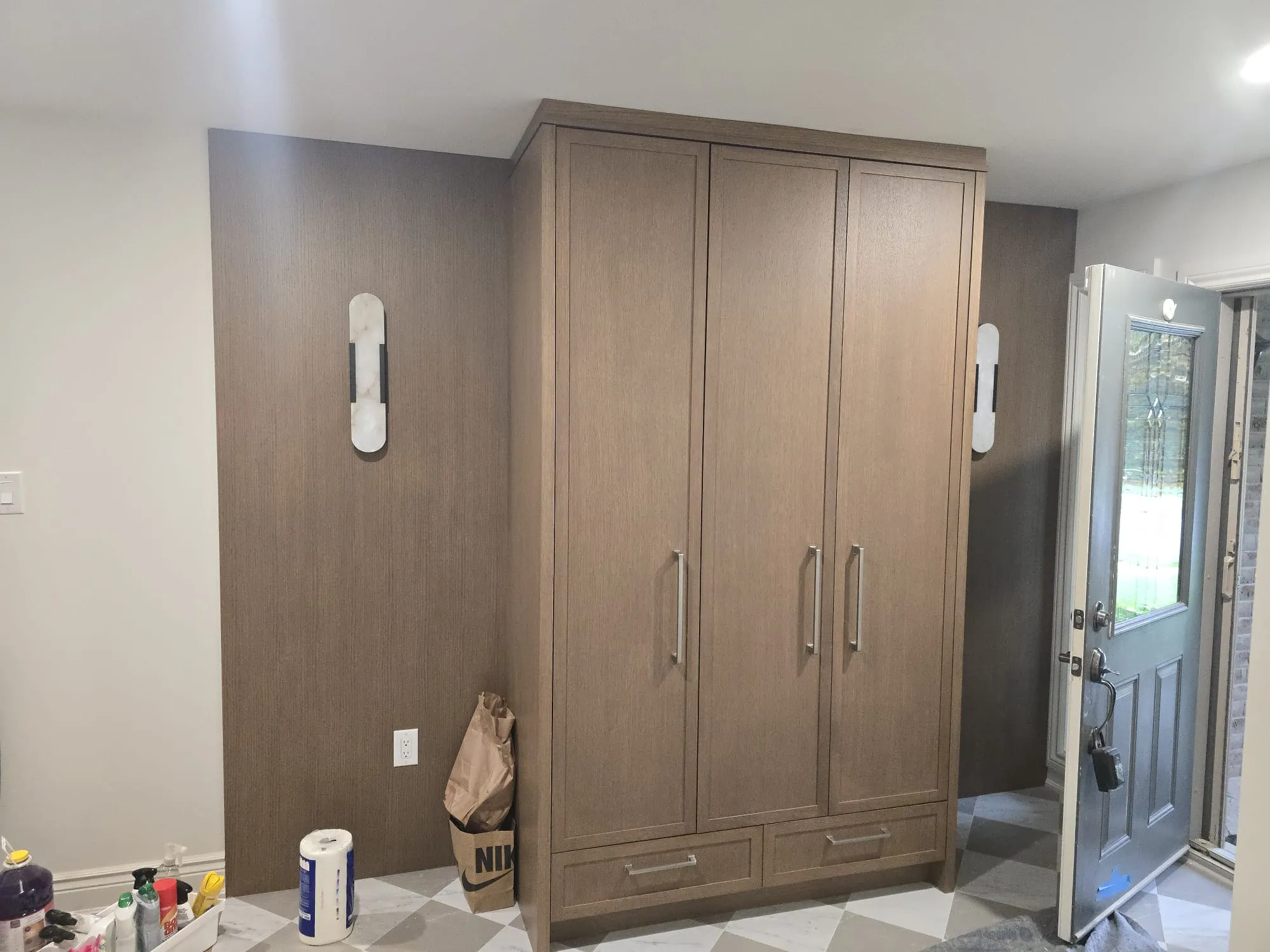 Floor-to-ceiling warm wood pantry and appliance cabinetry