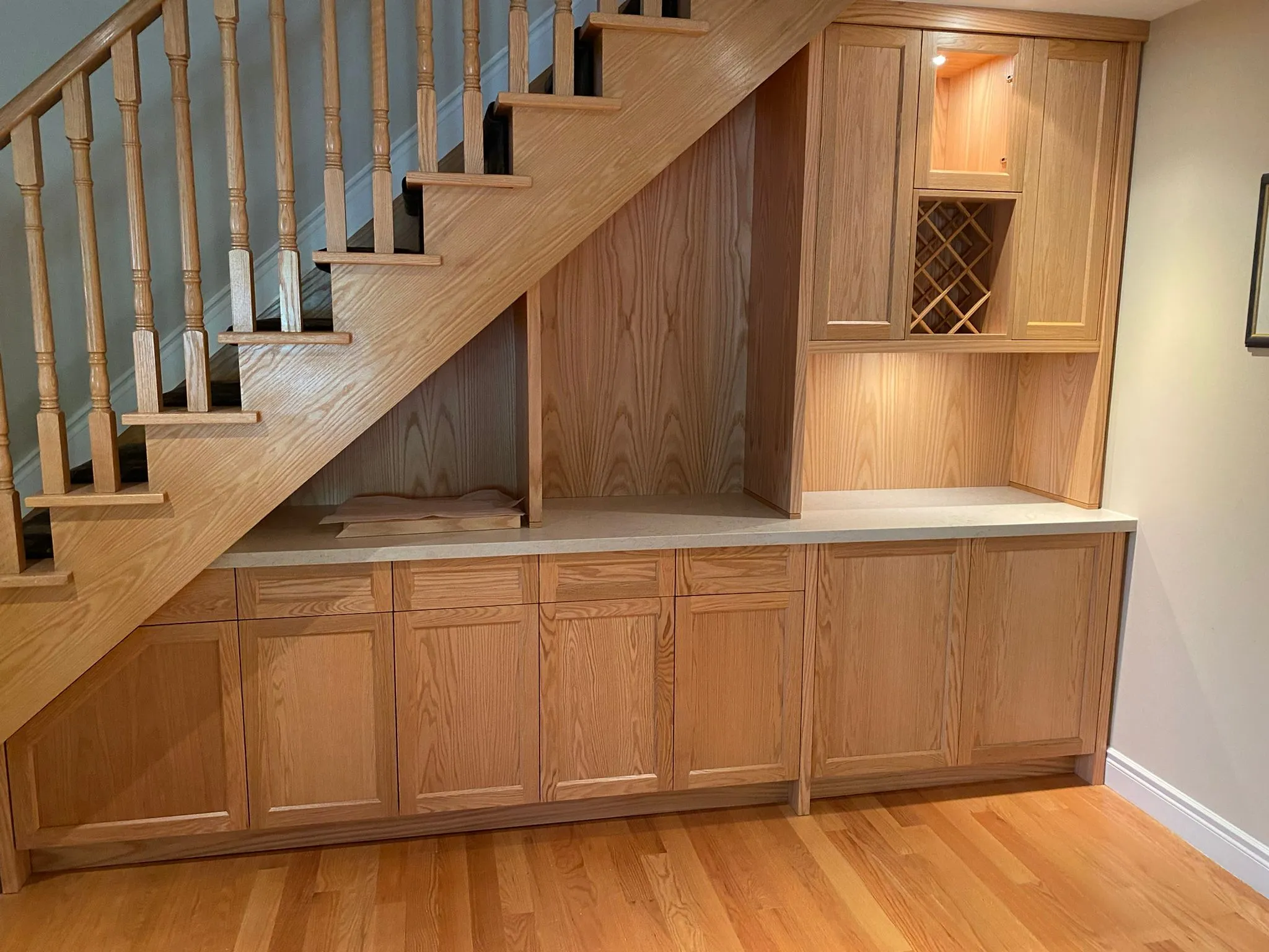 Custom wood cabinetry fitted beneath a staircase
