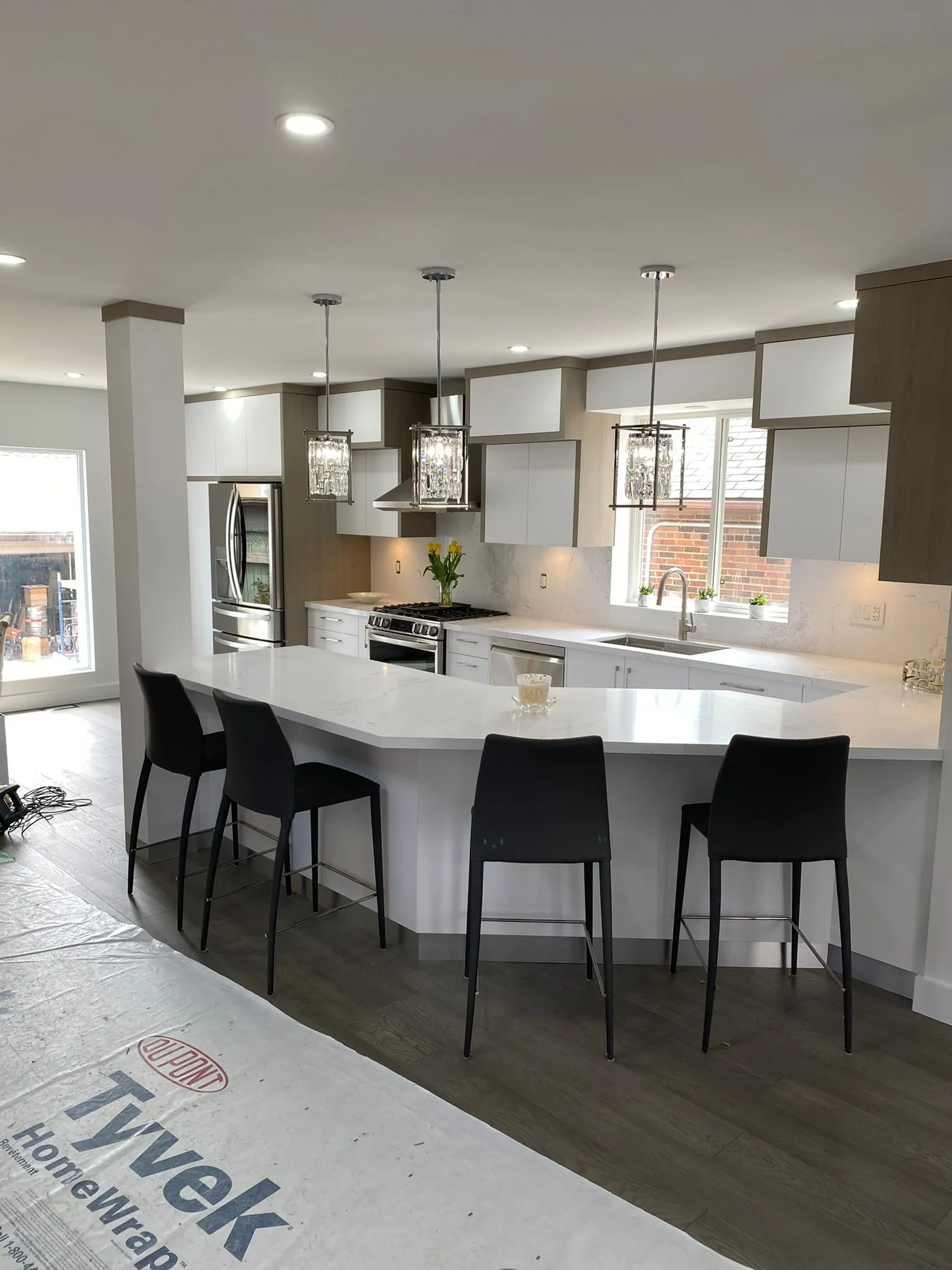 Bright white custom kitchen with a wood island and seating