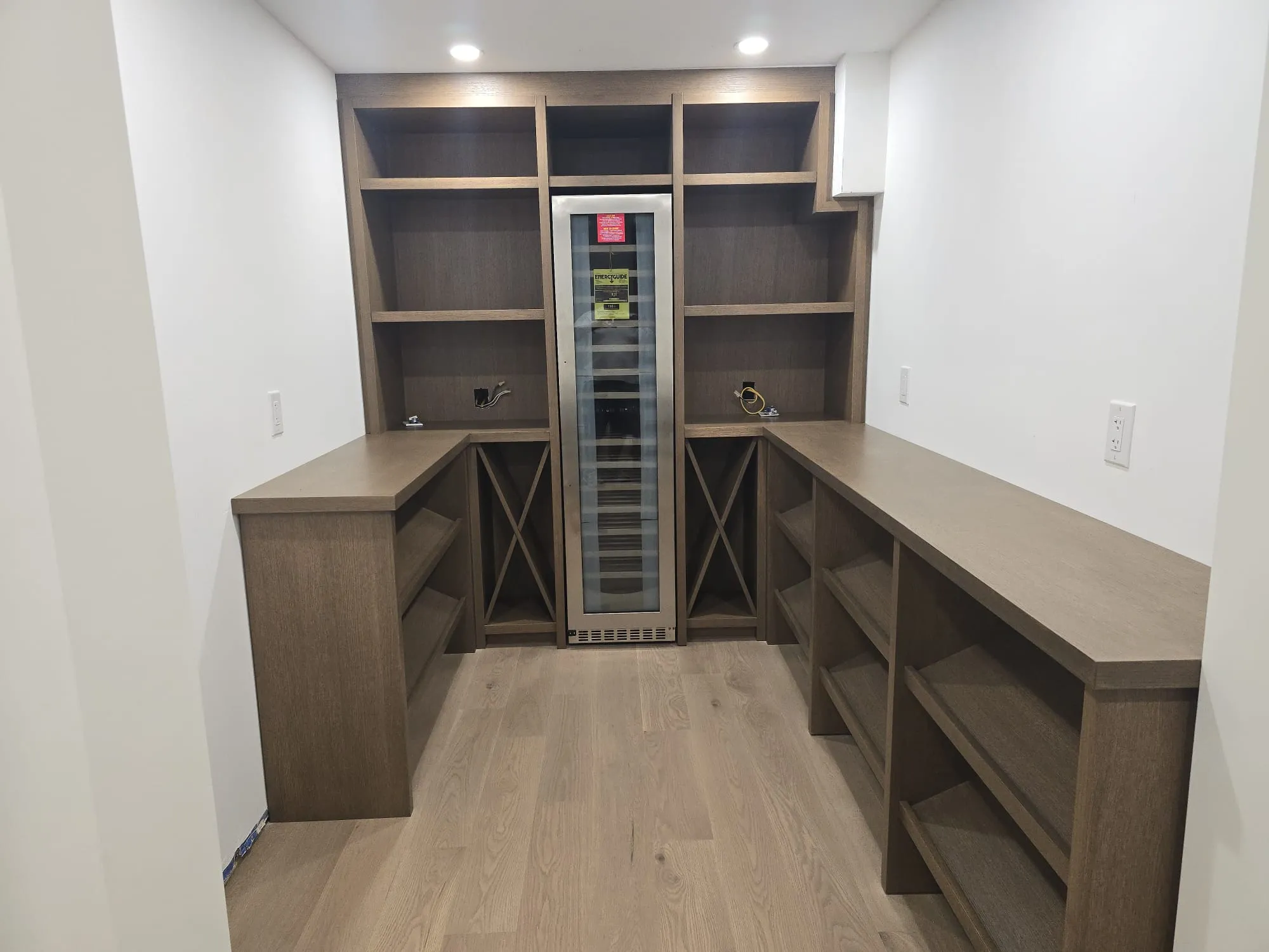Custom wood wine room with a central bottle rack